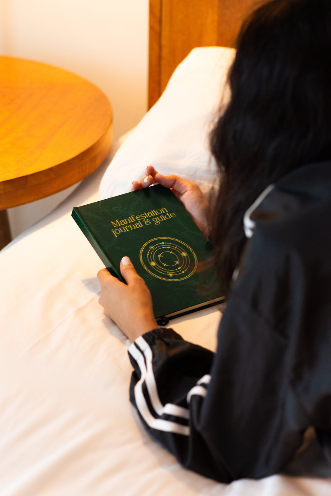A Sri Lankan girl holding the Manifestation Journal and Guide
